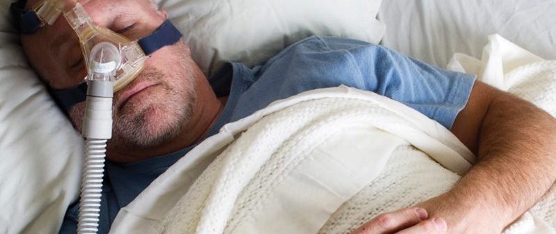 A man sleeping with a CPAP machine