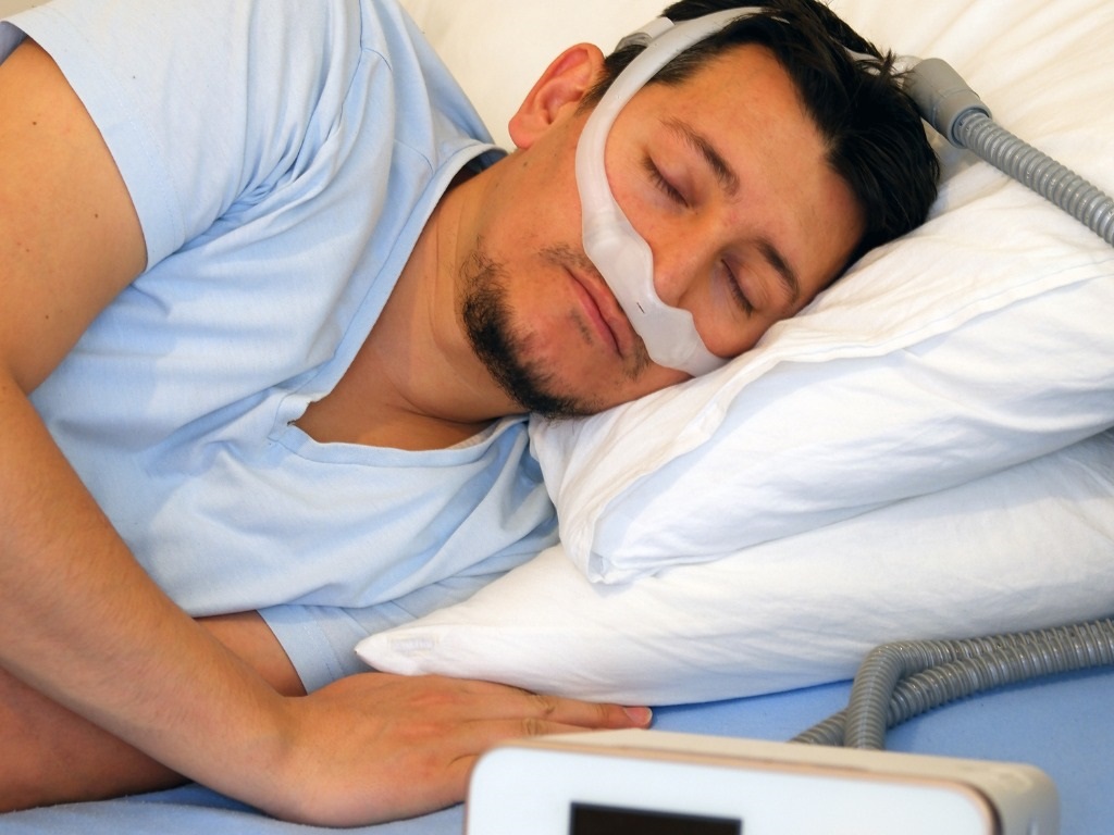 man wearing under the nose nasal mask and using cpap machine for picture id1191282564