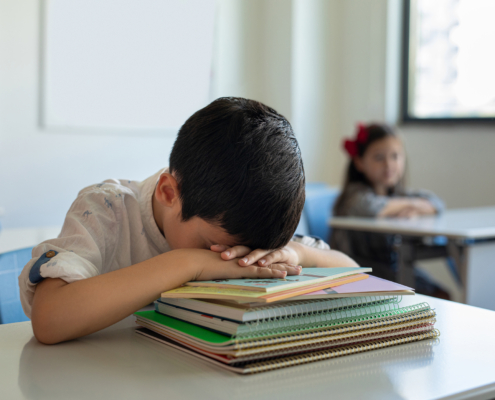 child sleeping at school