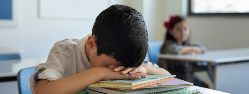 child sleeping at school